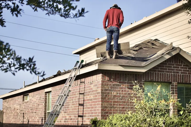 Professional roofer working on a residential roof in Lane Park